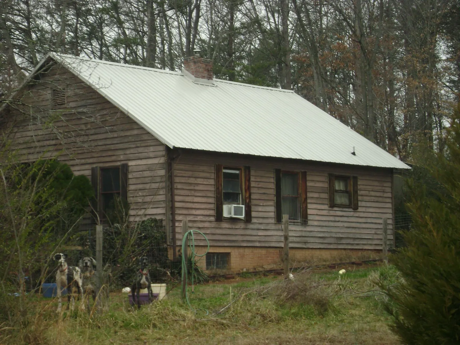 White metal roof on an old wood sided farmhouse, from a Metal Roof Installation job in Crete
